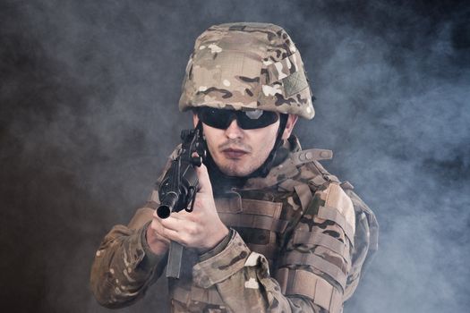 Modern soldier with rifle isolated on a black background