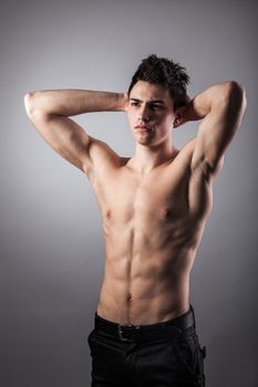 Portrait of young bodybuilder man on a black background