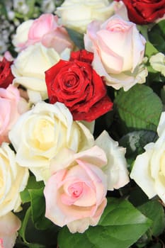 pink, red and white roses in a floral arrangement