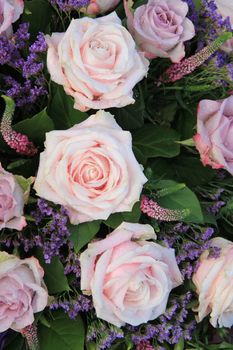Big pale pink roses in a floral arrangement 