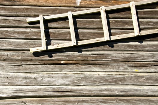 background of old retro log house wall and wooden ladder hanging.