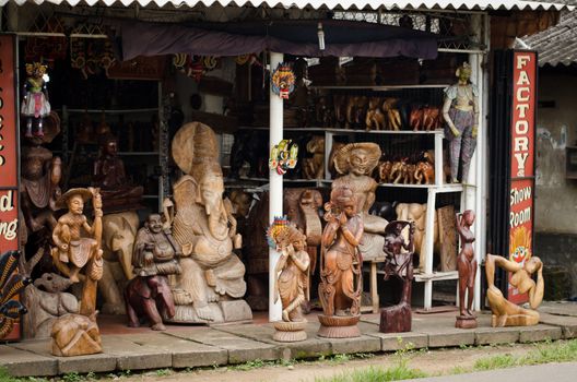 Bentota, Sri Lanka - December 14, 2011: Traditional asian wooden souvenir shop with various figures