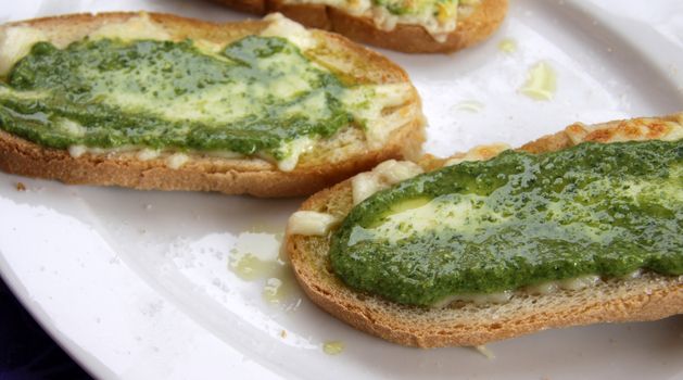 Delicious pesto and cheese toast, made with olive oil from the Liguria region of Italy. 