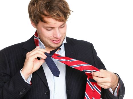 ties - man can not tie his tie. Young professional business man trying tying his tie getting ready isolated on white background. Funny young caucasian business man model.