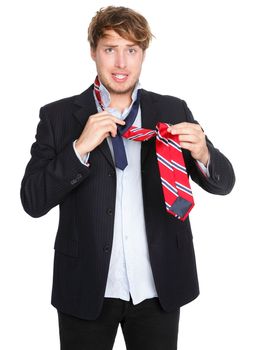 Man tying a tie. Funny man unable to tie his tie trying hard. Young male businessman in suit getting dressed isolated on white background.