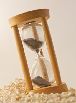 Wooden Hourglass with black sand over white sand