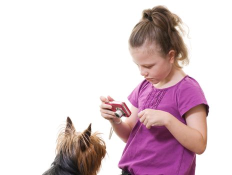 preteen girl taking photo of pet dog