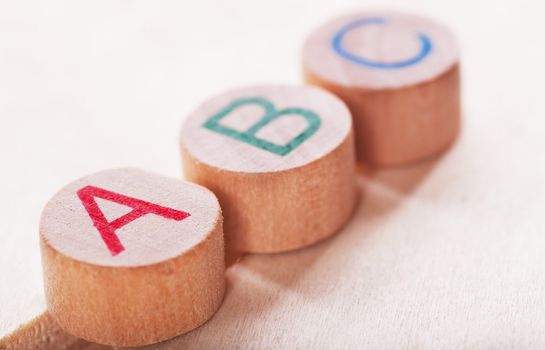 Three alphabet wooden blocks