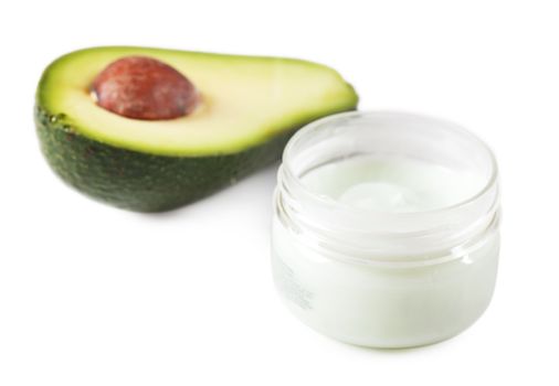 Natural cream and avocado over white background