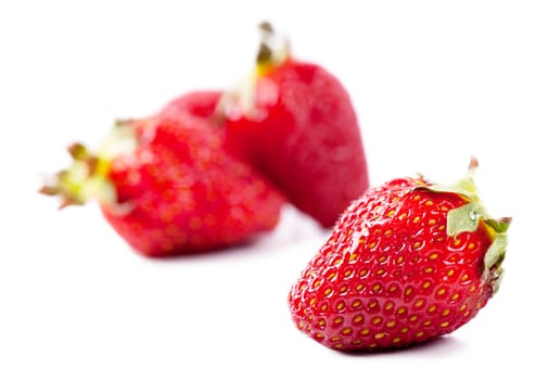Closeup view of fresh strawberries over white background
