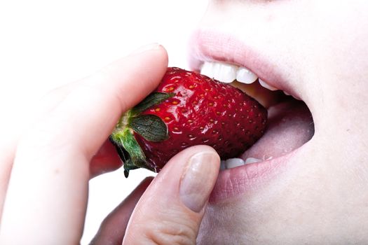 Young woman eating fresh juicy strawberry