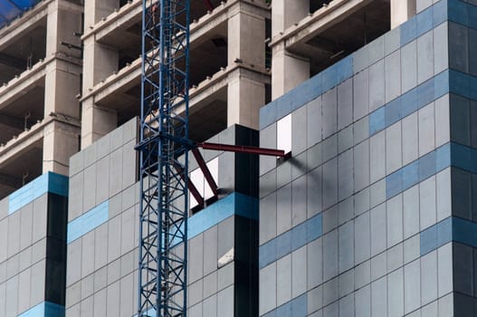 High rise construction site with crane in downtown Singapore