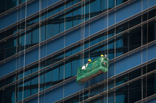 Two window cleaner working on a glass facade