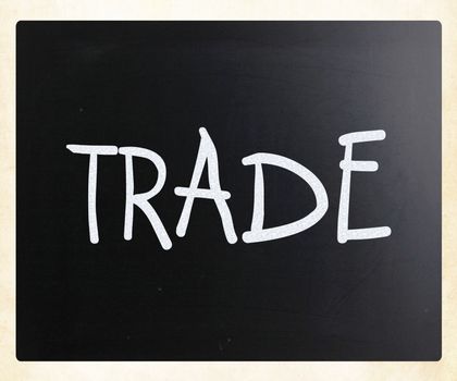 "Trade" handwritten with white chalk on a blackboard