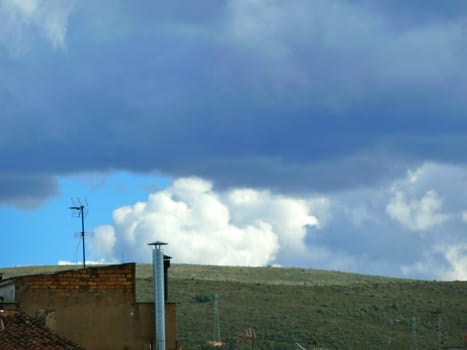 dramatic clouds with blue sky over mountains