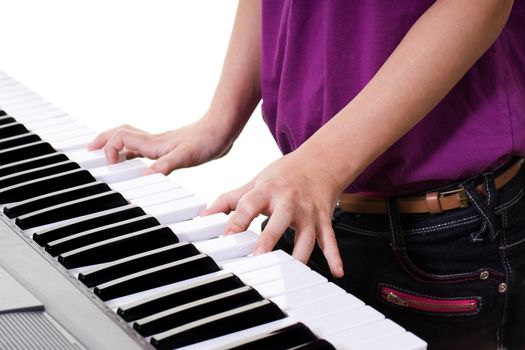 close up of young girl  playing keyboard
