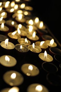 Some church candles against a dark background
