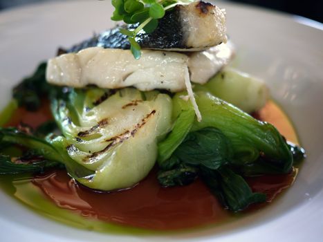 fish and bok choy on a plate