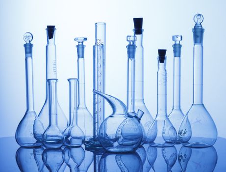 Research Lab assorted Glassware Equipment on blue background