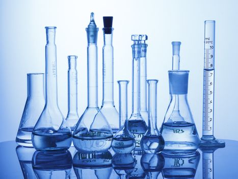 Research Lab assorted Glassware Equipment on blue background