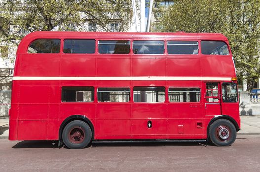 Side view of London red double deck bus.