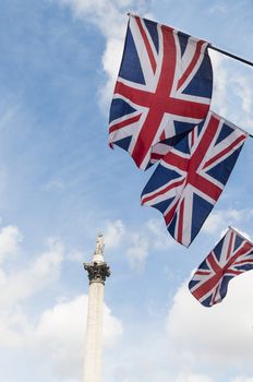 British Union flags in row, with Nelson column in background.