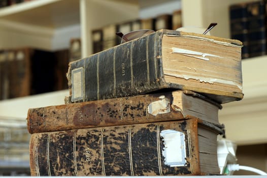 Stack of three old books to show the wear of age.