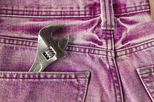 Red jeans pocket with old tool
