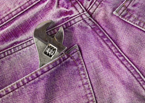 Red jeans pocket with old tool
