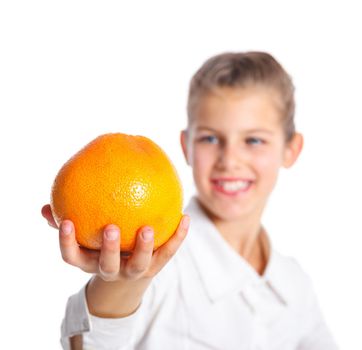 Portrait of happy cute little girl with orange. Focus on the orange. Isolated over white background.