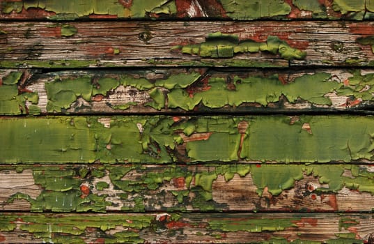 Old railway wagon wooden side green boards peeled coats as background