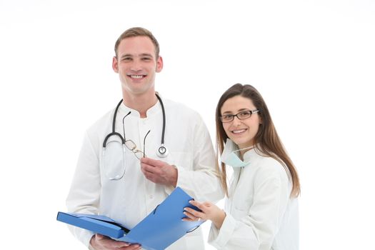 Smiling young male doctor and his female assistant or nurse standing holding a blue folio discussing patient records