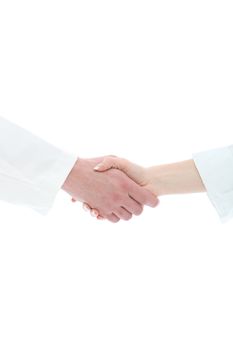 Cropped view of a male and female hand in white medical uniform sleeves clasped in a handshake conceptual of a greeting, success, thanks or agreement