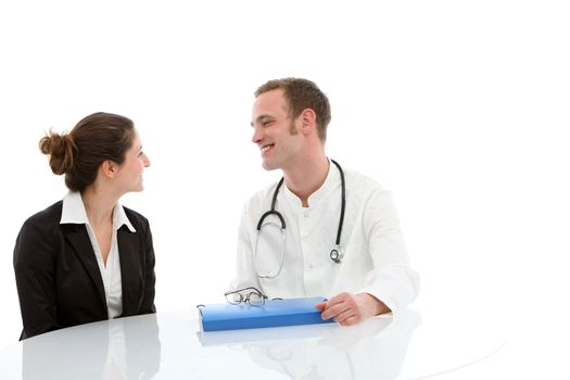 Friendly young doctor sitting at a table with a file talking to a female patient during a consultation