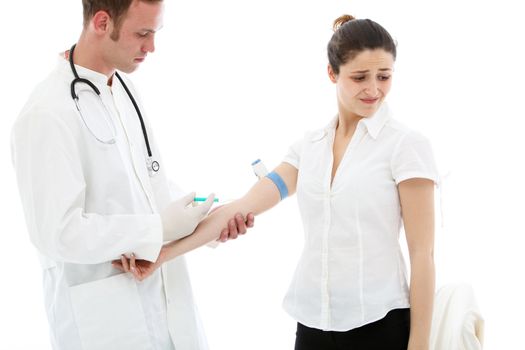 A young male doctor, student or nurse administering an intravenous injection to a female patient who is looking away with a grimace