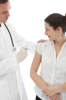 Young male doctor administering an intramuscular injection to a female patient in her upper arm