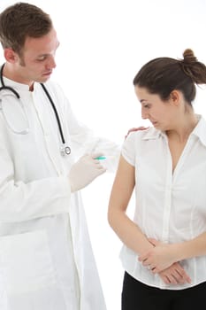 Woman grimacing as she receives an intramuscular injection in her upper arm from a doctor, nurse, or student intern