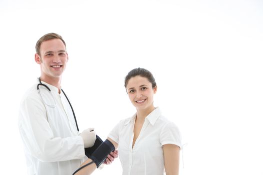 Smiling doctor applying blood pressure cuff to the upper arm of a female patient isolated on white