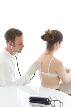 Doctor listening to a woman's lungs and breathing with a stethoscope during an examination