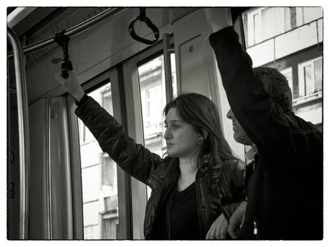 YOUNG COUPLE IN TRAM, ISTANBUL, TURKEY, APRIL 16, 2012: Young Turkish couple on their way home from job late afternoon, Istanbul, Turkey.