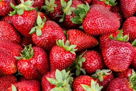 Red juicy strawberries closeup, background.