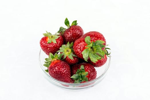 Some fresh strawberries in glass container.