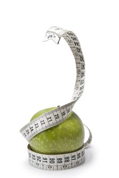 Tape measure simulating a snake wrapped around an apple.