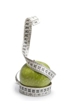 Tape measure simulating a snake wrapped around an apple.