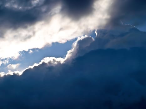 a part of sunny sky between storm clouds