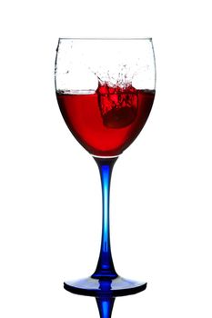 The red wine pouring into a wine glass.