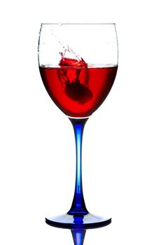 The red wine pouring into a wine glass.