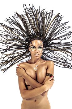 Portrait of a beautiful naked young african american woman with dreadlocks hair lying on a white background