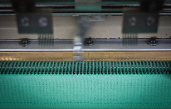 Close up on a machine weaving