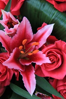 roses and tiger lily combined in a mixed flower arrangement